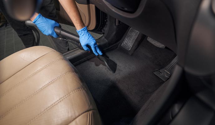 Professional worker cleaning car interior