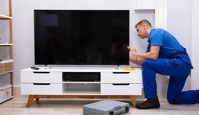 A technician is repairing TV