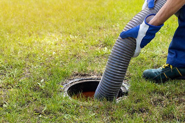 Professional worker cleaning septic tanks