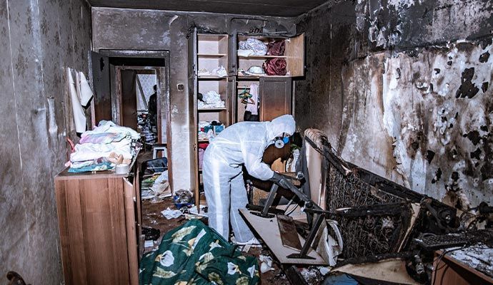 Restoration experts cleaning and repairing a residential fire-damaged area.
