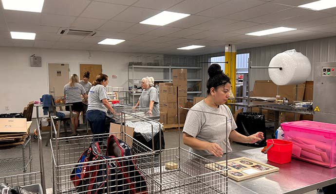 Content restoration service Technicians are carefully cleaning and restoring household items after damage.