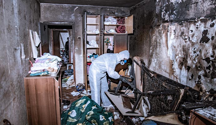 Technician cleaning fire damaged room