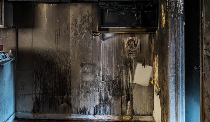 Wall burnt cabinet soot stains on fire damaged kitchen