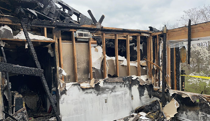 Severe structural fire damage The charred remains of a house interior after a fire.