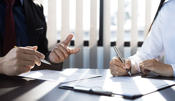 People signing insurance claim documents