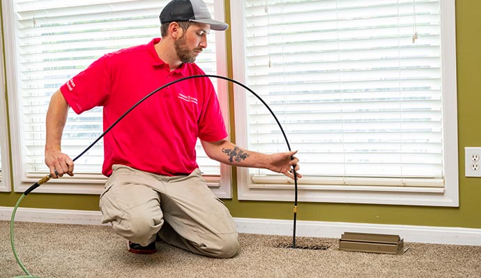 Professional worker cleaning duct vent