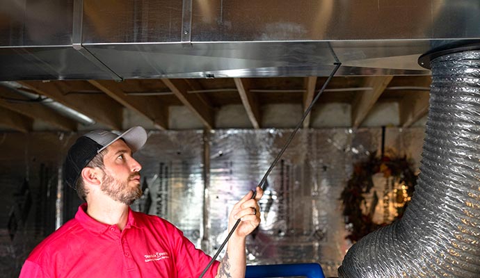 Professional worker cleaning ducts