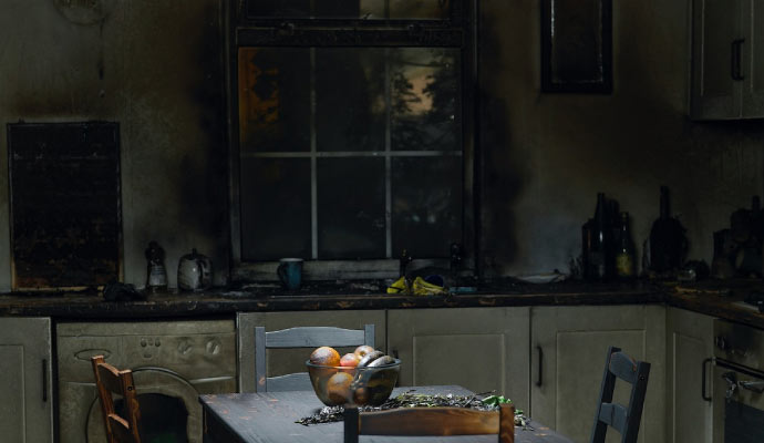 Fire damaged kitchen with smoke and soot