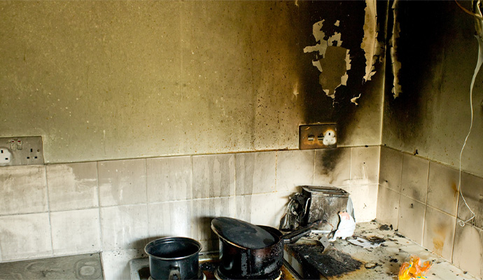 Soot damaged kitchen wall around a countertop