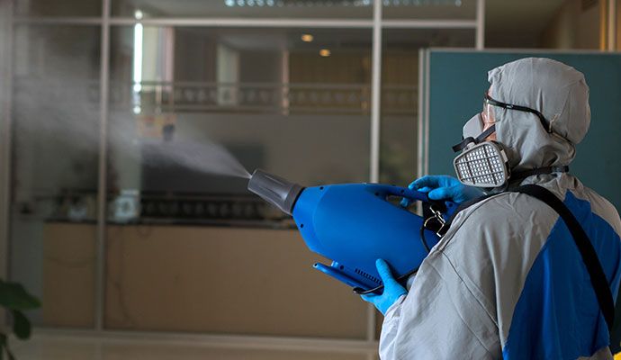 Technician using a thermal fogger for deodorization