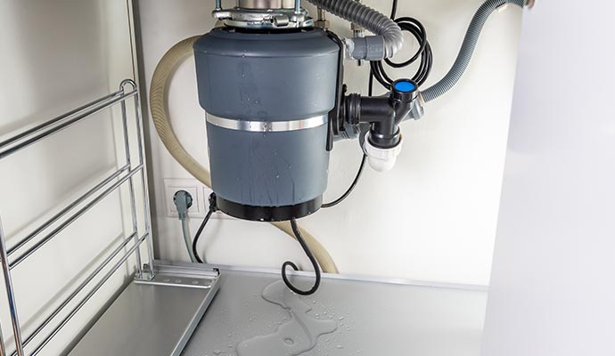 Leaked garbage disposal under the sink